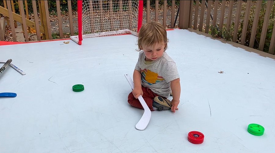 child using RapidIce synthetic ice outdoors